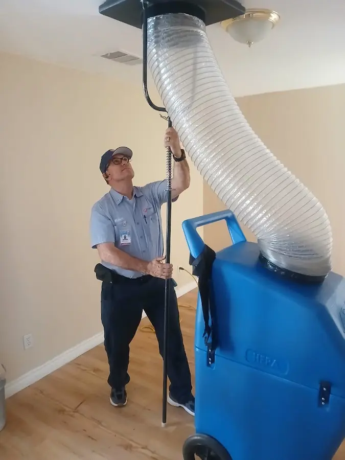 Furnace Tune-Up technician using HEPA equipment in Van Buren